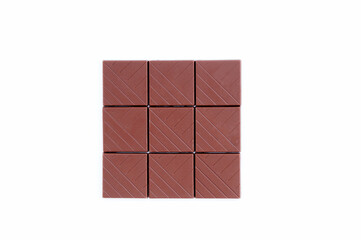 Bars of slices of milk chocolate on white background.