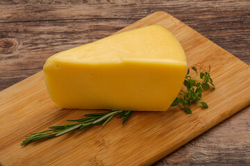 Hard cheese piece served rosemary