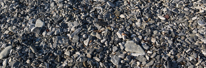 seamless pattern of polished stones in a rocky beach