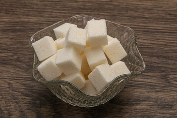 Refined white sugar cubs in the bowl