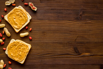 Spread peanut butter sandwiches with nuts. Top view