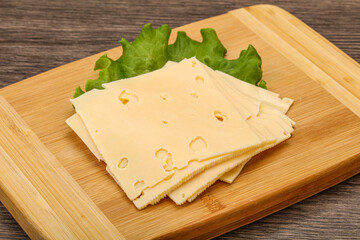 Sliced yellow cheese over board