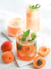 Glass of ice non-alcohol fresh apricot fruit mojito soda mixed with mints,a cool fresh drink for refreshing in summer 