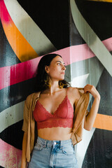 Caucasian woman posing in front of colorful background. Young and attractive model.	