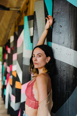 Caucasian woman posing in front of colorful background. Young and attractive model.	