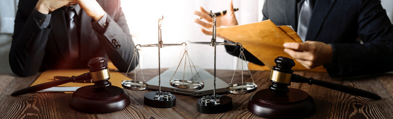 Business and lawyers discussing contract papers with brass scale on desk in office. Law, legal...