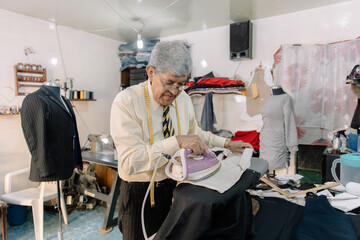 experienced mexican tailor ironing clothes