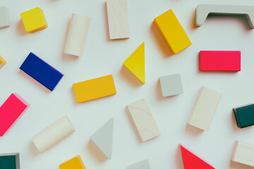Multi-colored wooden cubes. Baby toys pattern on a white background.