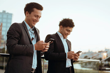 Two financiers have met and are using the phone. Working on a new project of a colleague.