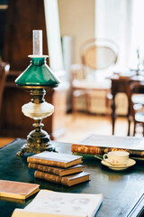 interior of an old house cabinet with books, wooden furniture and lamp
