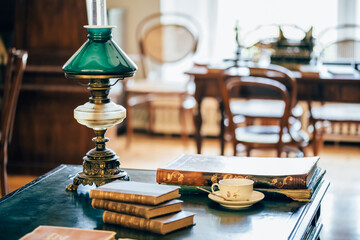 interior of an old house cabinet with books, wooden furniture and lamp