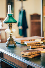interior of an old house cabinet with books, wooden furniture and lamp