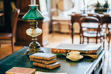 interior of an old house cabinet with books, wooden furniture and lamp