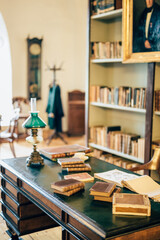 interior of an old house cabinet with books, wooden furniture and lamp