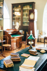 interior of an old house cabinet with books, wooden furniture and lamp