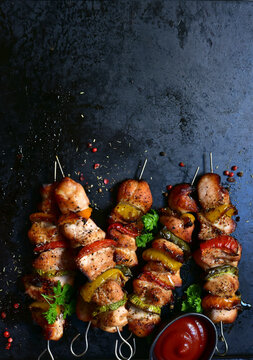 Chicken kebab skewers with grilled vegetables . Top view with copy space.