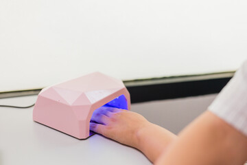 manicure fingernail dryer in beauty salon treatment. Beautician latin professional lifestyle