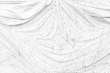 Light grey background. Abstract texture. Sculpted folds from ancient marble statue