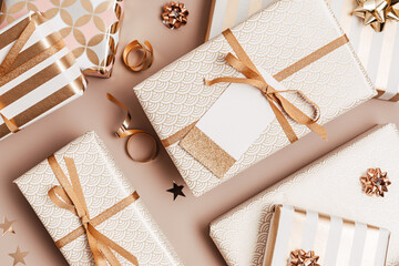 Christmas background with gift boxes wrapped in golden colored paper. Xristmas celebration,...