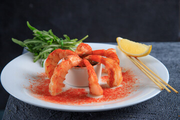 Fried shrimps on a plate with vegetables
