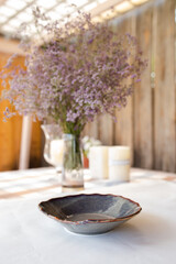 decorative table setting with beautiful dishes and flowers