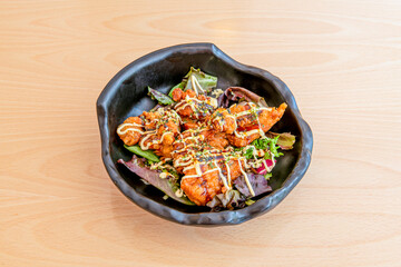 Fried breaded chicken with Ghanaian shito sauce on black bowl