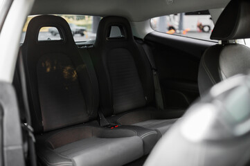 Inside of a vehicle. Back seats of a car. Empty comfortable back of a car.
