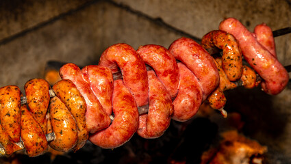 Typical Brazilian barbecue with country sausage on a skewer roasted over the grill