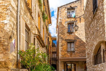 Fototapeta na wymiar Picturesque stone medieval homes and apartments inside the walled village of Tourrettes-Sur-Loup in the Provence, Alpes-Maritimes region of southern France.