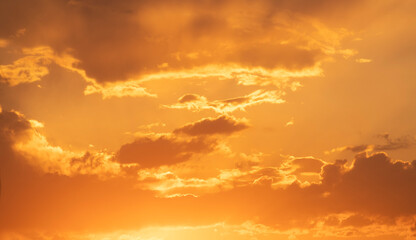 Naklejka na ściany i meble Beautiful golden dark sunset sky with clouds. Sky after sunset background.