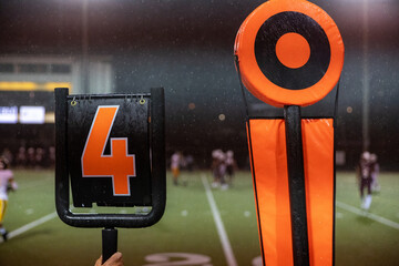 American football 4th down marker on rainy game day sideline on the field © Mat Hayward