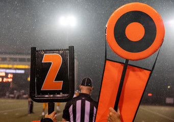 American football second down marker on rainy game day sideline on the field