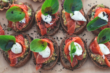 Catering table, beautifully decorated banquet with variety of with different food snacks and appetizers on corporate birthday party event or wedding celebration, seafood, canape, delicatessen setting