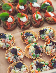 Catering table, beautifully decorated banquet with variety of with different food snacks and appetizers on corporate birthday party event or wedding celebration, seafood, canape, delicatessen setting