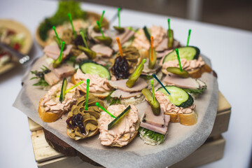 Catering table, beautifully decorated banquet with variety of with different food snacks and appetizers on corporate birthday party event or wedding celebration, seafood, canape, delicatessen setting