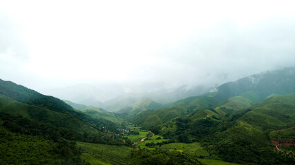 Aerial drone shot Landscape Panorama view, mountain range with morning fog natural background at Sapan village, Nan Province, Northern Thailand.