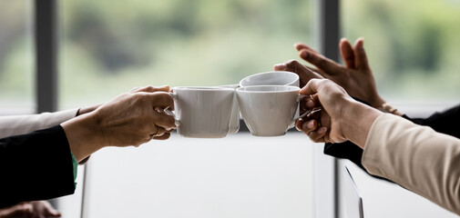 Closeup shot of cups of coffee in hands of unrecognizable unidentified businesswoman colleague...