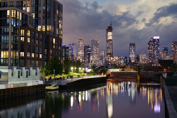 Fototapeta na wymiar Skyscraper, towers in Downtown Brooklyn seen from Gowanus Canal during sunset