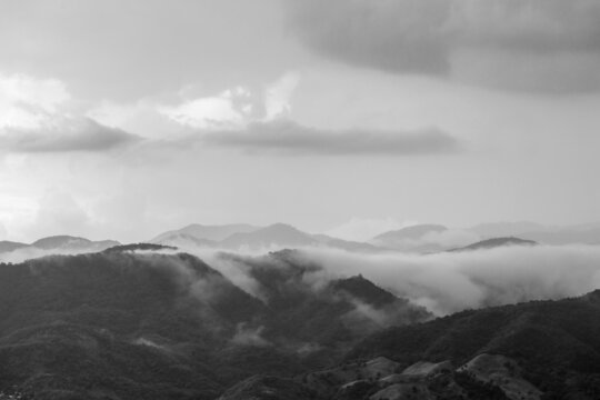 Dramatic black and white image of clouds over mountains in the Caribbean island of the Dominican Republic.