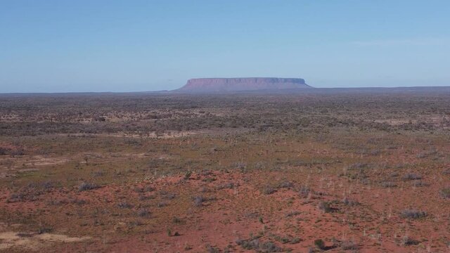 a winter morning aerial ascending view of mt conner in the northern territory of australia