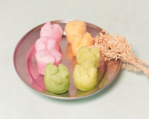 Colorful apem cake isolated on black background. Apem cake is a food made from rice flour which is left overnight by mixing eggs, coconut milk, sugar and tape and a little salt then steamed.Focus blur