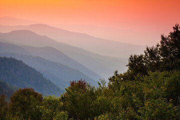 Morning breaks over the mist shrouded hills of the Oconaluftee Overlook in the Great Smoky Mountains National Park