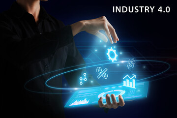 Naklejka premium Business, Technology, Internet and network concept. Young businessman working on a virtual screen of the future and sees the inscription: Industry 4.0