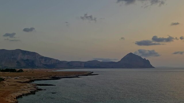 Panning view of beautiful Baia Santa Margherita bay of Macari in Sicily at sunset. Italy