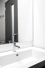 Bathroom interior with sink and faucet, wide angle.