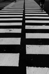 black and white crosswalking biker