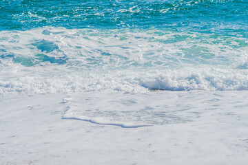 Ocean waves rolling on sandy beach