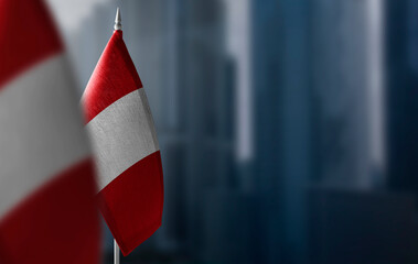 Small flags of Peru on a blurry background of the city