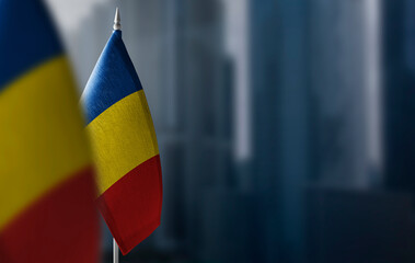 Small flags of Romania on a blurry background of the city