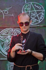 A man dressed as a priest. Halloween image. Вlack magic.
